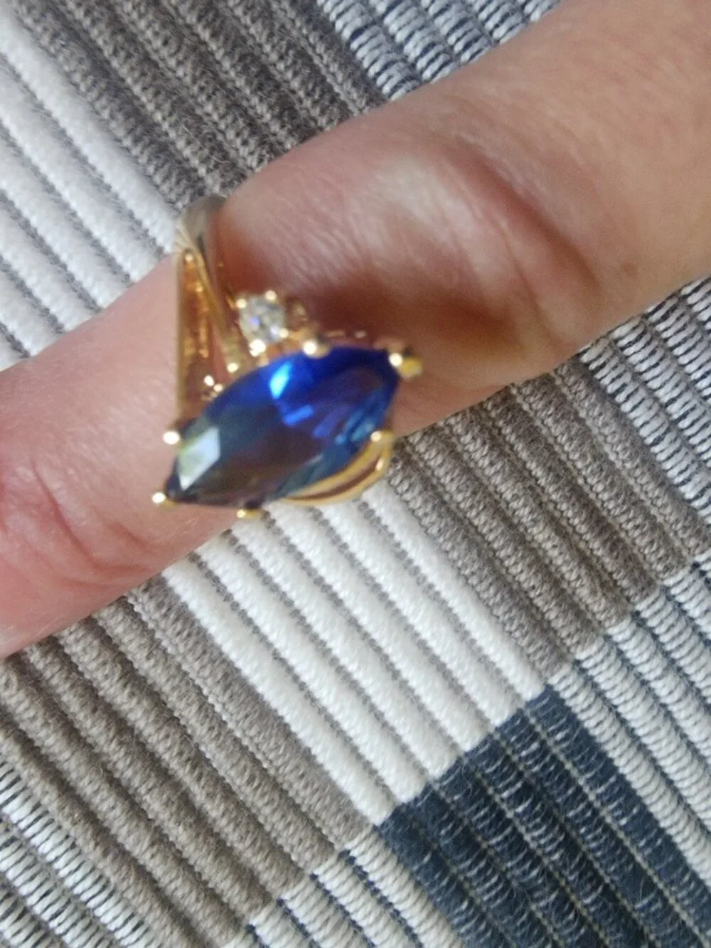 Gold colored band w/ ocean blue stone. Size 5.5